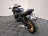 a motorcycle that is sitting on a stand in a room