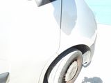 a white car parked on the side of the road