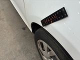 a sticker on the side of a white car that has a ruler on it