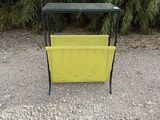 a yellow bench sitting in the middle of a gravel road