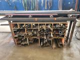 a bunch of metal pipes are stacked on top of a table