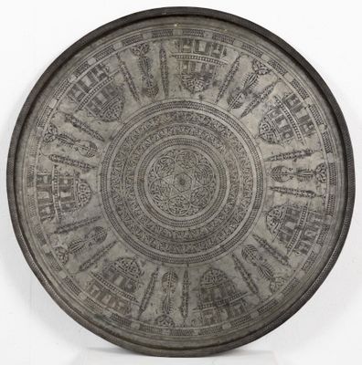 an image of a metal plate with designs on it