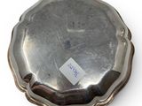 a silver plate with a tag on it on a white surface