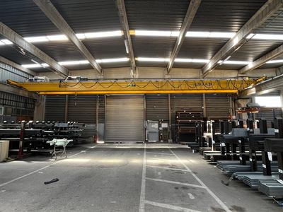 a large warehouse with a crane in the middle of it