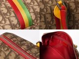 a brown bag with a red handle and a yellow handle