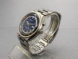 an image of a watch with a blue dial on a clear watch stand
