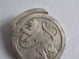 a close up of a silver coin with a lion on it