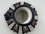 a black and white cup and saucer sitting on a table