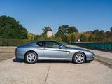 a silver sports car parked on the side of the road