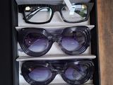 many pairs of sunglasses sitting in a box