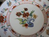 a plate with a floral design on it sitting on a table