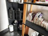 a shelf with many different types of hair products on it