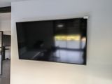 a flat screen tv mounted on the wall in the living room