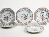three plates with floral designs on them sitting next to each other