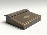 a small wooden box with a book on top of it