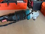 a drill that is sitting on the floor next to other tools