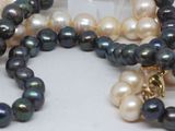 many different colored pearls on a necklace on a table
