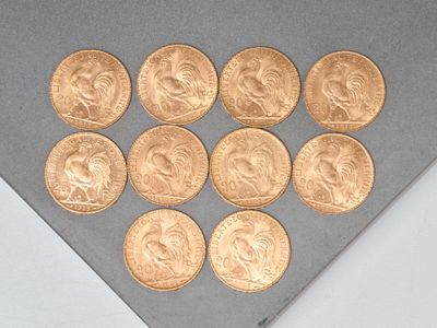 several gold coins are arranged in a triangle on a gray surface