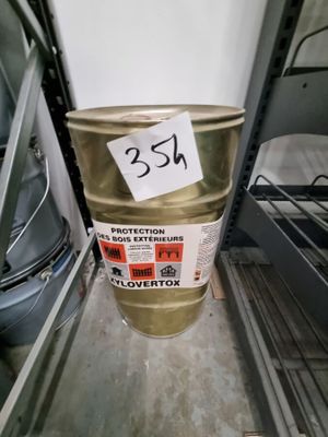 un fût métallique sur lequel est collé un autocollant, dans un magasin