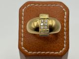 an image of a gold ring with a diamond set in the center