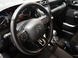 the interior of a car with a steering wheel and dashboard controls