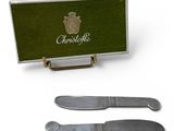 two knifes and a knife holder with a green box on a white background