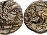 an ancient coin with a head of a lion and a face of a lion