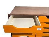 an image of an orange filing cabinet with drawers and a wooden top