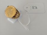 a close up of a ring with a gold coin on it