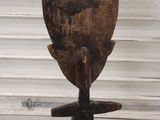 wooden sculpture of a man with a hat on his head