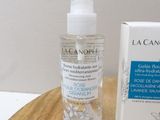 a bottle of lotion sitting on a table next to a box