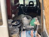 a white van with a bunch of items in the back of it