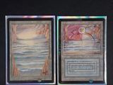 two cards that are on a table with a black background