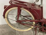 a red bicycle with a basket on the back of it