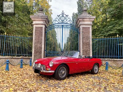 a red sports car parked in front of a gate