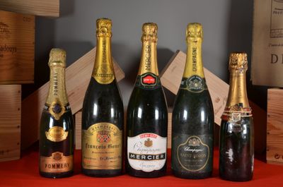several bottles of champagne are lined up on a red table