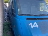 a blue van that is parked next to a building