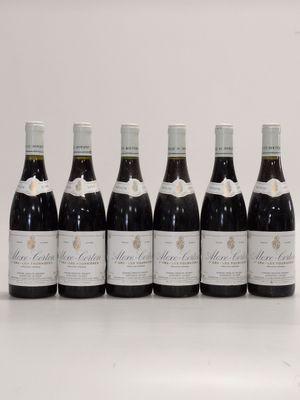 six bottles of wine lined up in a row on a table
