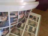 a stack of photos on a table next to a red bag
