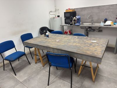 a table and chairs in a room with tile flooring
