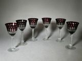 six verres à vin sont alignés sur une table