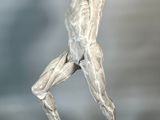 statue of a man standing on a rock with his hands in the air