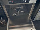 a stainless steel dishwasher that is open on the counter
