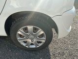 a white car that is parked on the side of the road