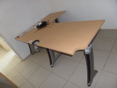 a desk with a computer on it in a room