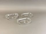 three clear plastic containers sitting on top of a white surface