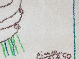 a white rug with a drawing of a cupcake on it