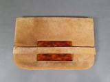 tan leather clutch bag with tortoises on the front