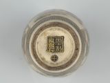 an image of a silver vase with a chinese writing on it