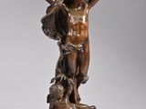 an antique bronze statue of a man with a dog
